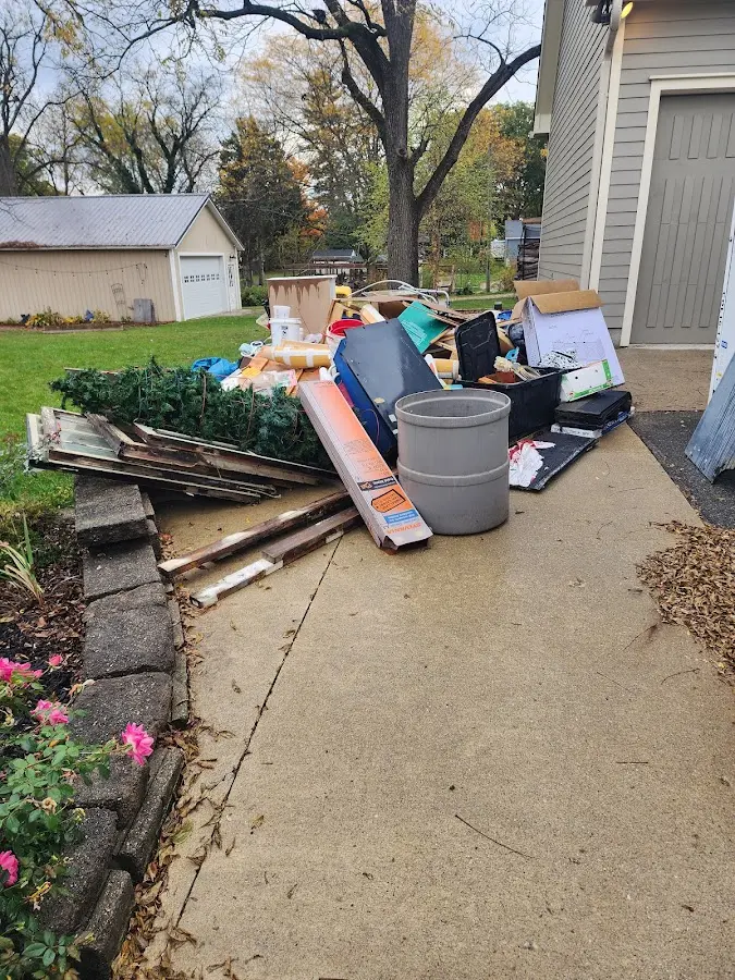 Dumpster being loaded with debris for Estate Cleanout Dumpster Rental in St. Augustine